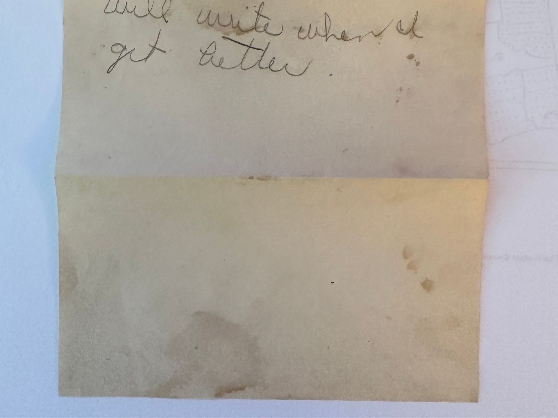 The back of a letter is shown. The writing is in cursive. The paper is old and weathered.