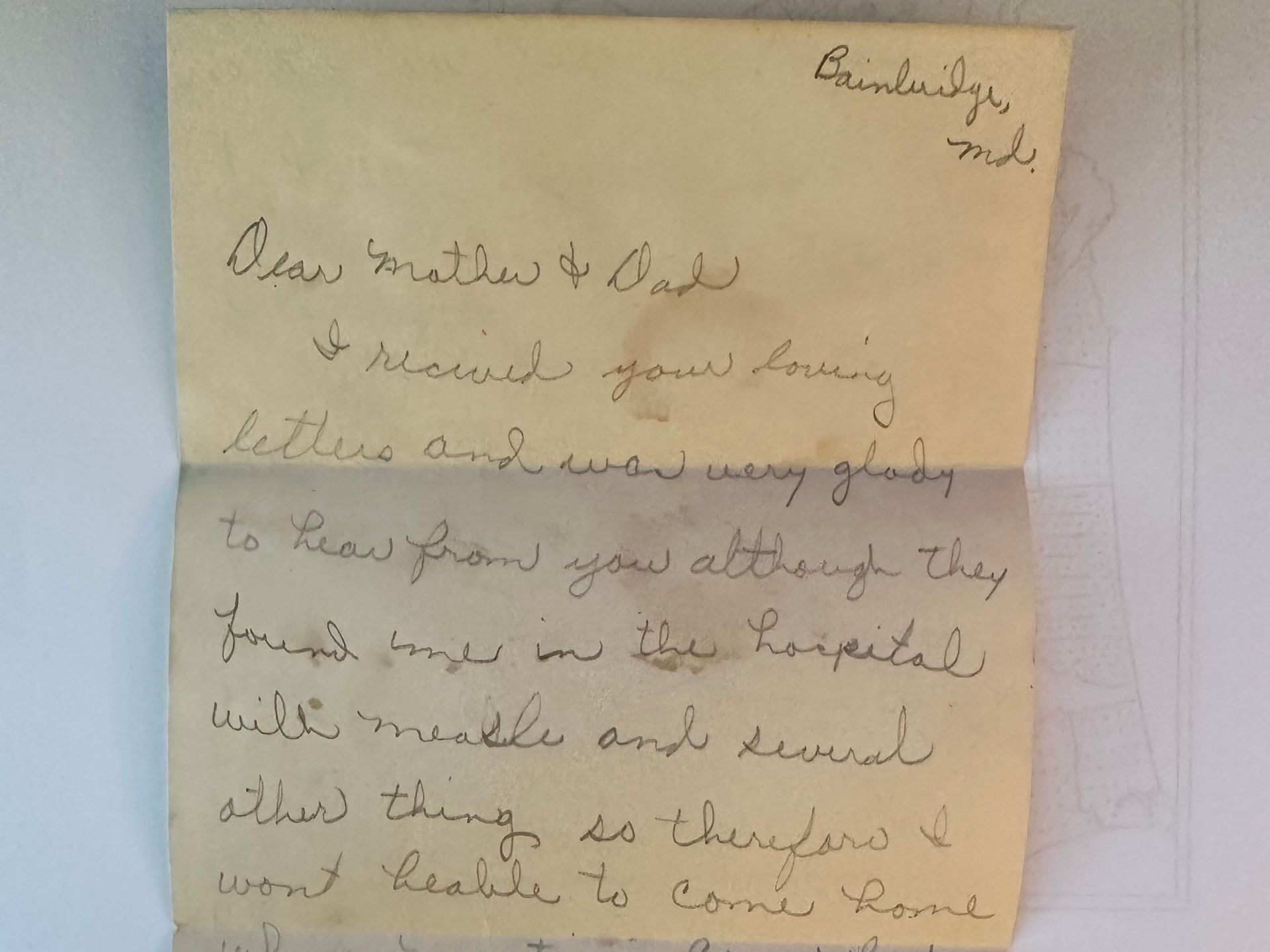 A letter with cursive handwriting is shown. The paper is old and weathered. The ink is dark.